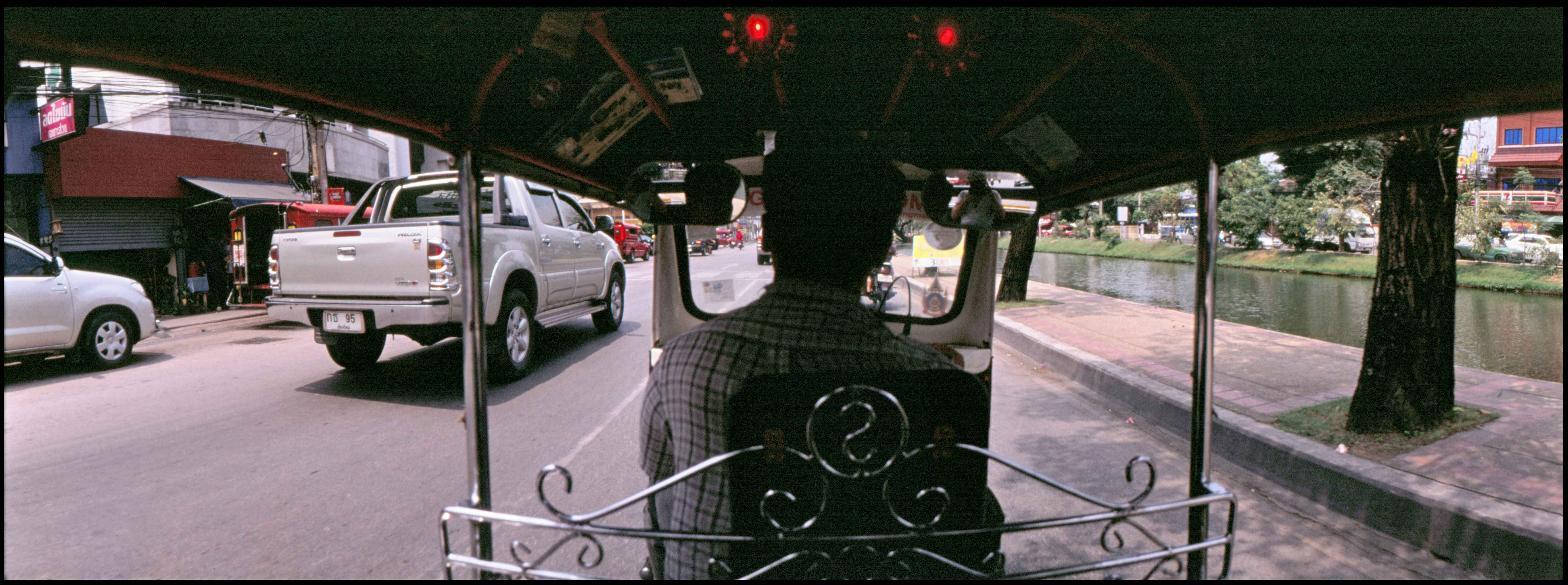 rear-view-man-driving-tuk-tuk-street_11zon.jpg
